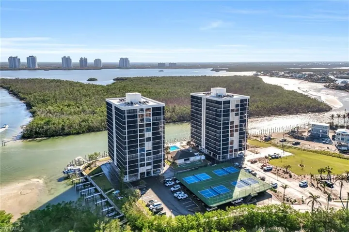 Birds eye view of property with a water view