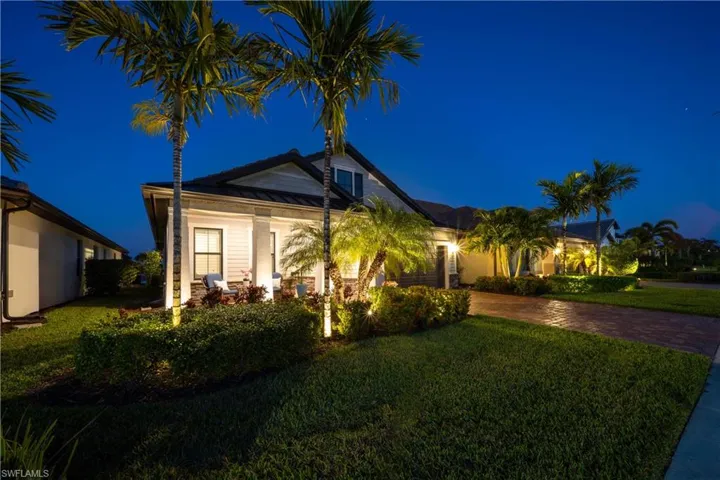 Sunset views of front of property featuring a landscape lighting