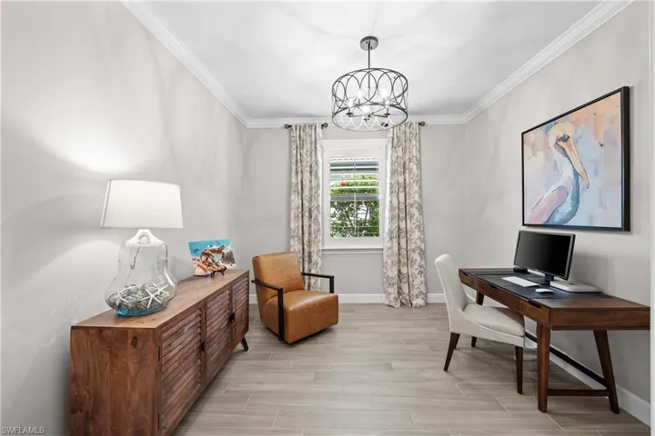 Office featuring added crown molding, tile and upgraded chandelier