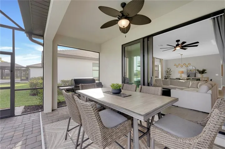 Sunroom with ceiling fan, outdoor dining area, an outdoor hangout area, and a patio area