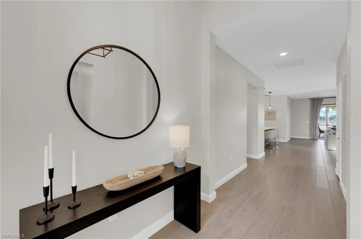 Corridor with light wood finished floors and recessed lighting