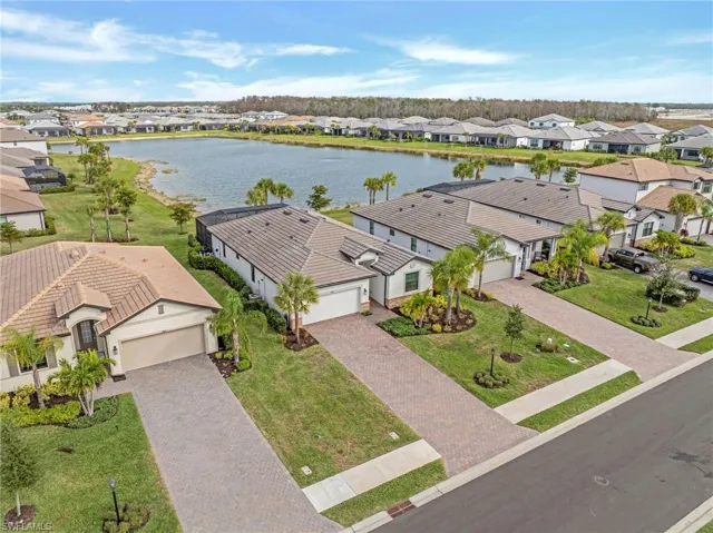 Aerial perspective of suburban area featuring a large body of water