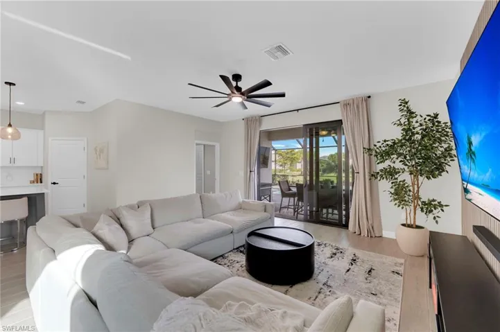 Living area featuring light wood-style floors and ceiling fan