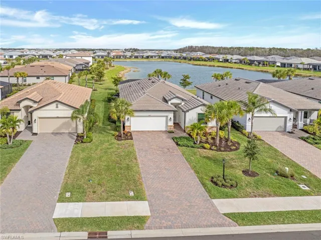 Aerial perspective of suburban area featuring a large body of water