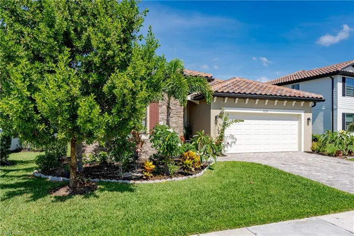 View of front of home featuring a garage and a front yard