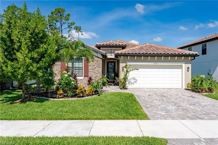 Mediterranean / spanish-style house featuring a garage and a front lawn