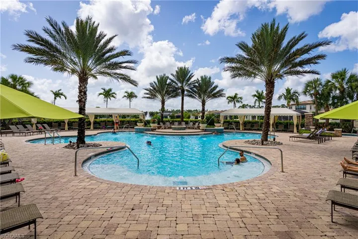 View of swimming pool featuring pool water feature and a patio area