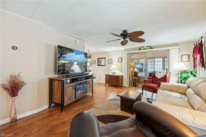 Living room featuring wood finished floors and a ceiling fan
