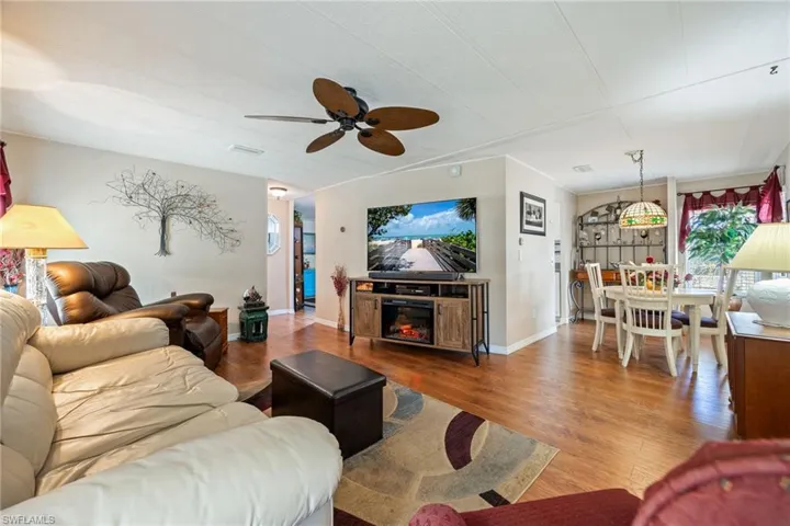 Living area with wood finished floors and ceiling fan