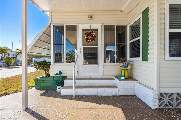 Doorway to property featuring a sunroom