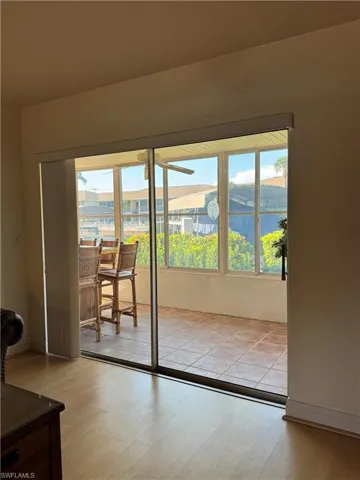 Doorway with a textured ceiling and light wood finished floors