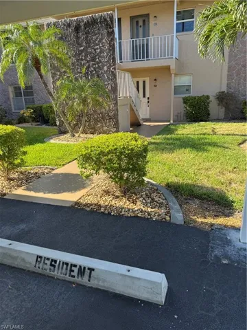 View of grassy yard featuring stairs