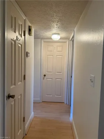 Carpeted bedroom featuring a textured ceiling and ceiling fan