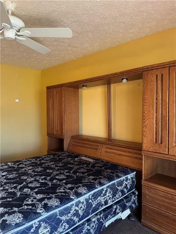 Full bathroom with a textured ceiling, tile patterned flooring, vanity, and a stall shower
