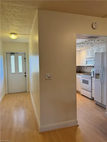 Doorway to property featuring stucco siding