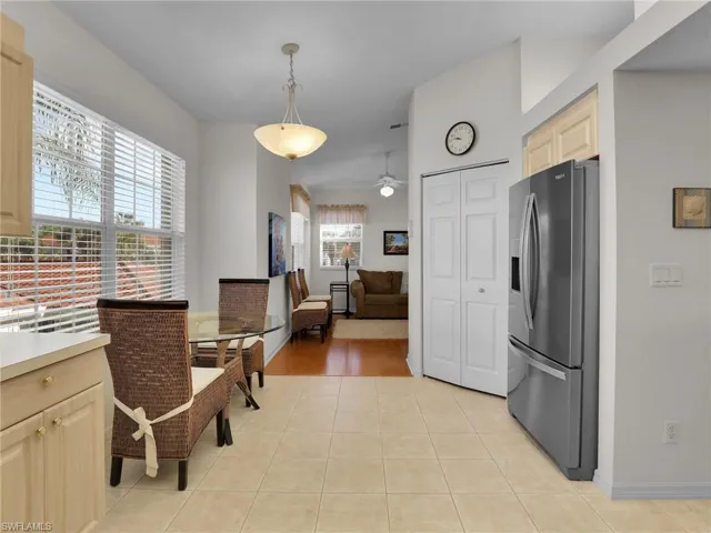 Tiled dining room featuring ceiling fan