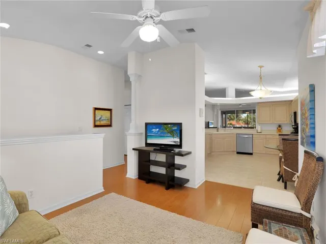 Living room featuring ceiling fan and light hardwood / wood-style floors