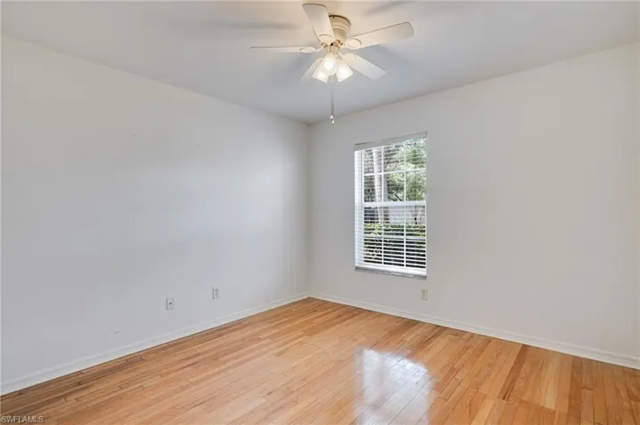 Unfurnished room featuring light wood finished floors and a ceiling fan