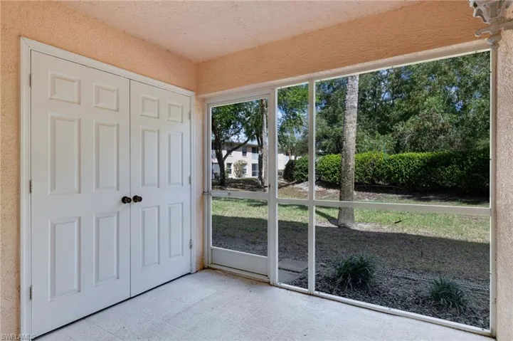 Doorway featuring a textured ceiling