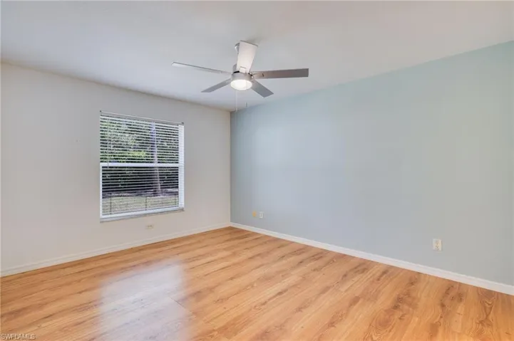Spare room with light wood-type flooring and a ceiling fan