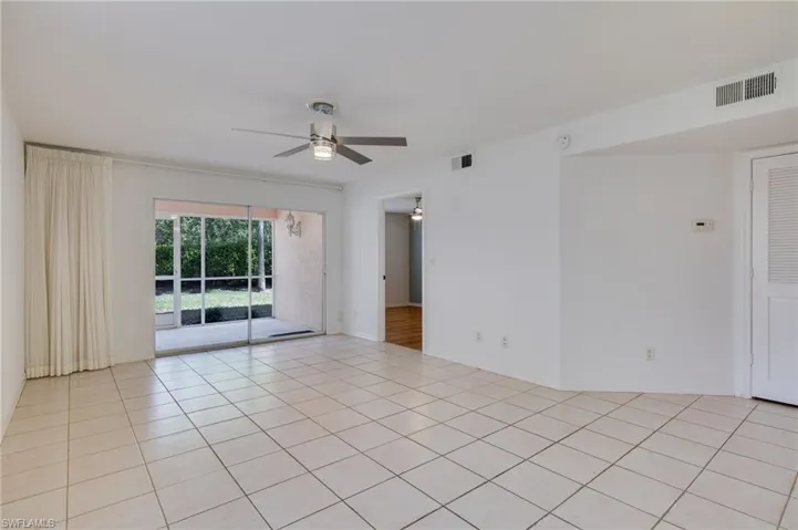 Spare room featuring a ceiling fan and light tile patterned flooring