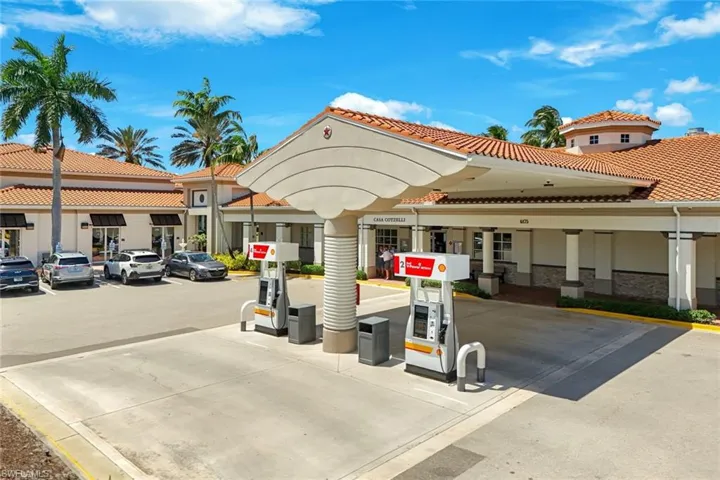 Commercial property featuring a Mediterranean-inspired architectural style with a terracotta tile roof and stucco facade