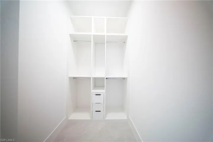 Unfurnished room featuring baseboards and light tile patterned flooring