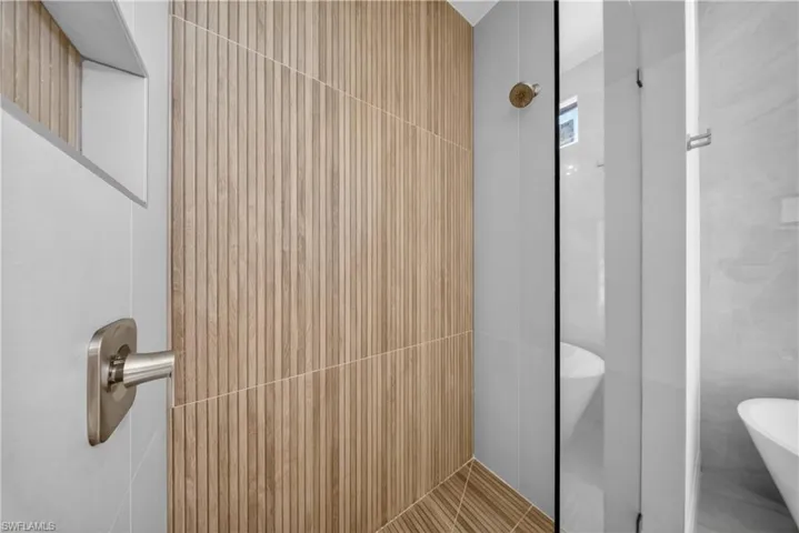 Full bathroom with two vanities and light tile patterned floors