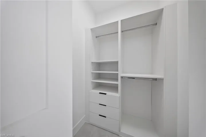 Spare room featuring a tray ceiling, finished concrete floors, and recessed lighting