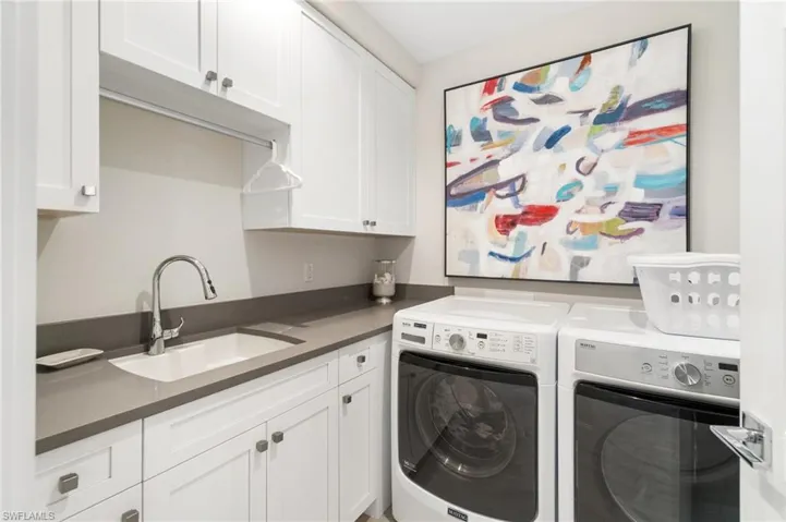Laundry area featuring cabinet space and washing machine and dryer