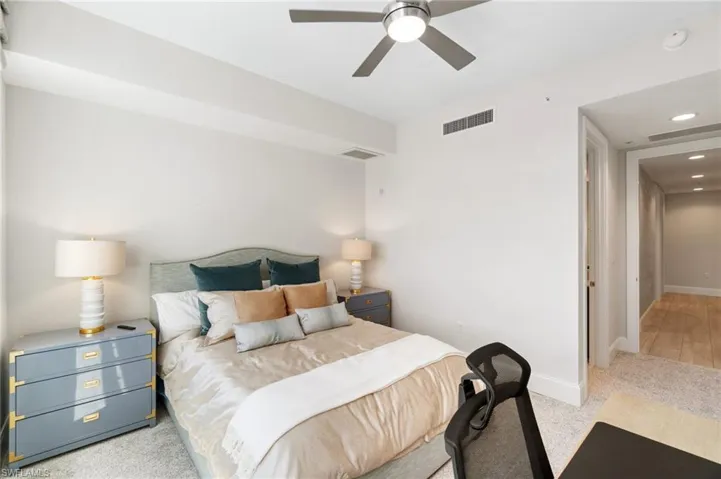 Carpeted bedroom featuring baseboards, a ceiling fan, and recessed lighting
