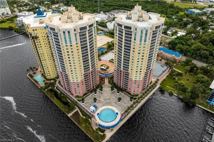 Bird's eye view of a nearby body of water and a pool area