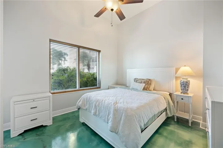 Guest Bedroom featuring a ceiling fan, door to patio, and high vaulted ceiling