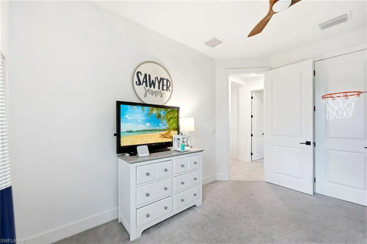 Bedroom featuring light colored carpet and ceiling fan