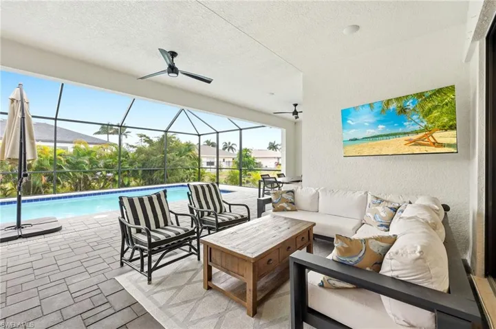 View of patio / terrace featuring a sunroom, ceiling fan, a lanai, and an outdoor hangout area