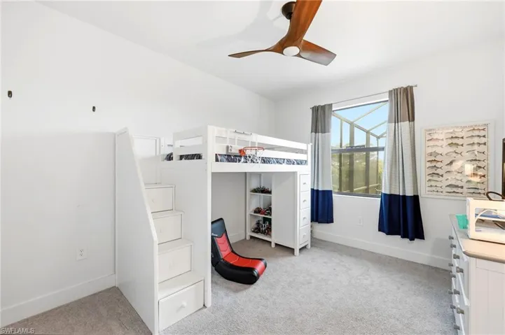 Bedroom with light colored carpet and ceiling fan