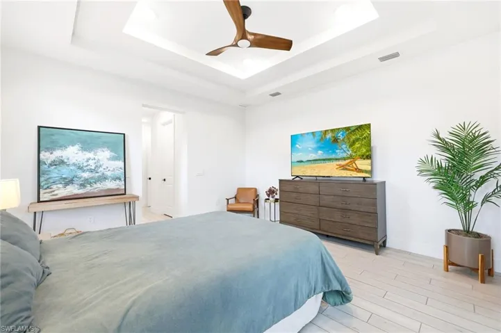 Bedroom with a ceiling fan and light wood-style floors