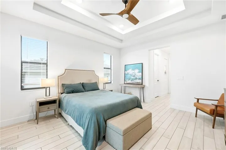 Bedroom with wood finish floors, a ceiling fan, and recessed lighting
