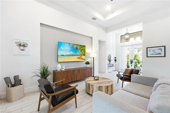 Living area with a towering ceiling and wood finished floors