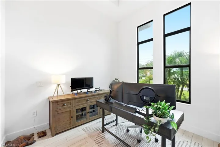 Office with baseboards and light wood-style floors