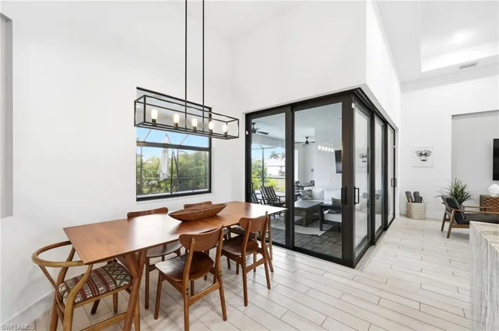 Dining area with wood tiled floors and a towering ceiling