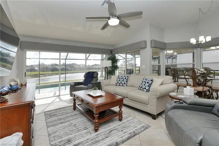 living room off kitchen and breakfast nook with the views of the pond #17 island green and water feature