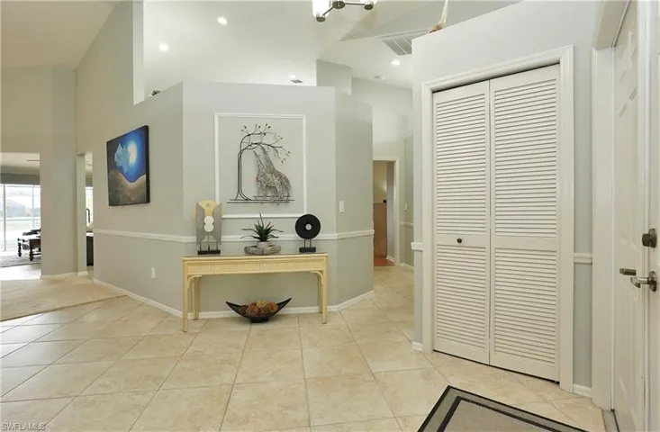 Foyer front entry closet to left is living area and pool right to primary