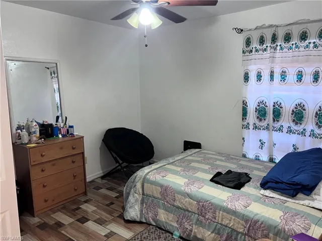 Bedroom with a ceiling fan and wood finished floors