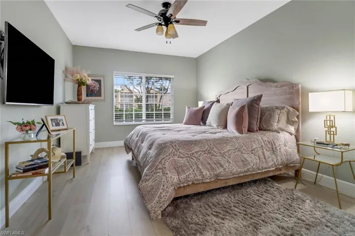 Bedroom featuring light hardwood / wood-style floors and ceiling fan