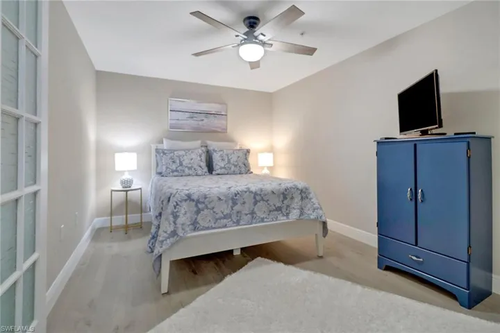 Bedroom with ceiling fan and wood-type flooring