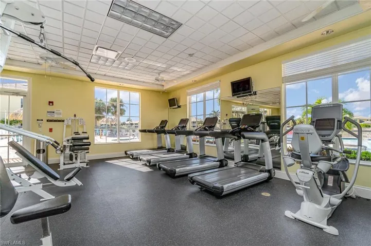 Workout area featuring a paneled ceiling and ceiling fan