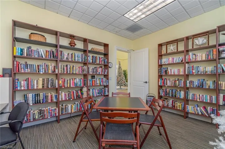 Carpeted office space featuring a drop ceiling