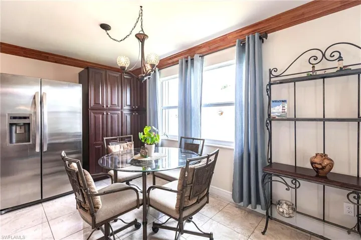 Dining room with a chandelier and ornamental molding
