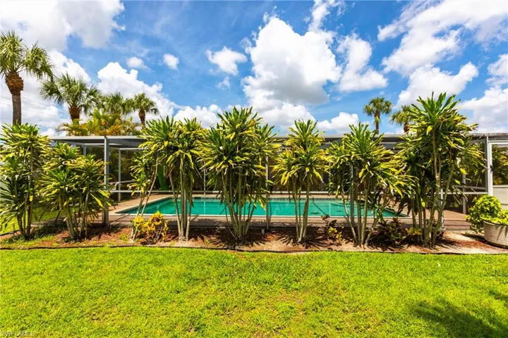 Outdoor pool featuring a yard and a lanai